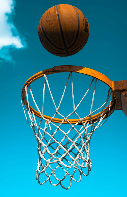 brown basketball hoop under blue sky during daytime