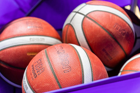 a basket filled with basketballs sitting on top of a table