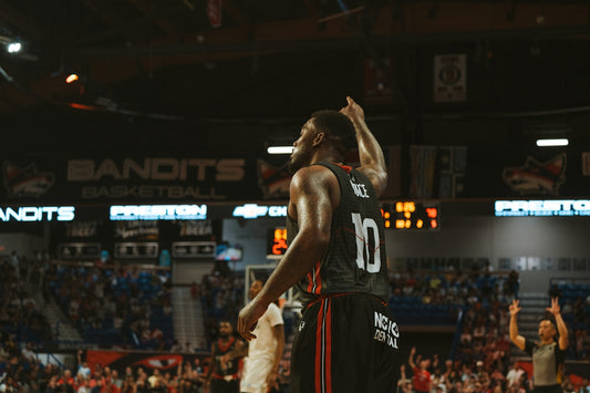 A basketball player celebrates a successful shot