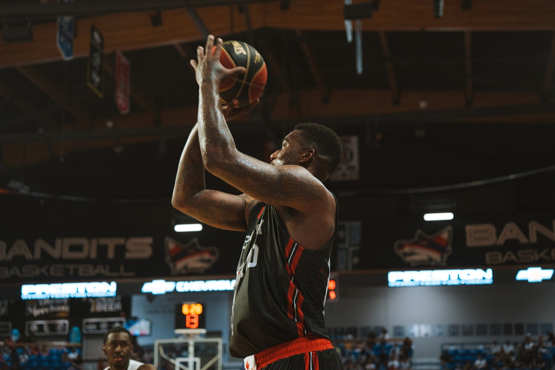 Basketball player shoots a basket during a game.