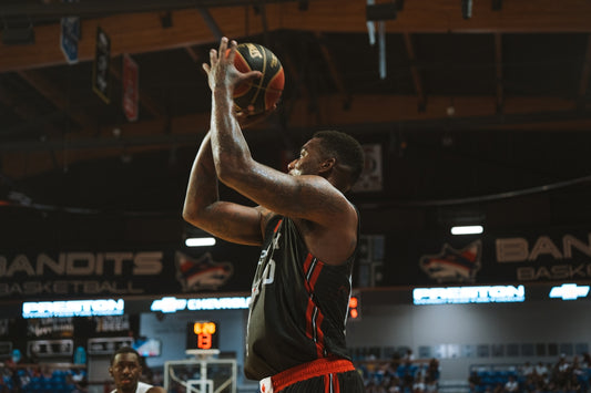 Basketball player shoots a basket during a game.