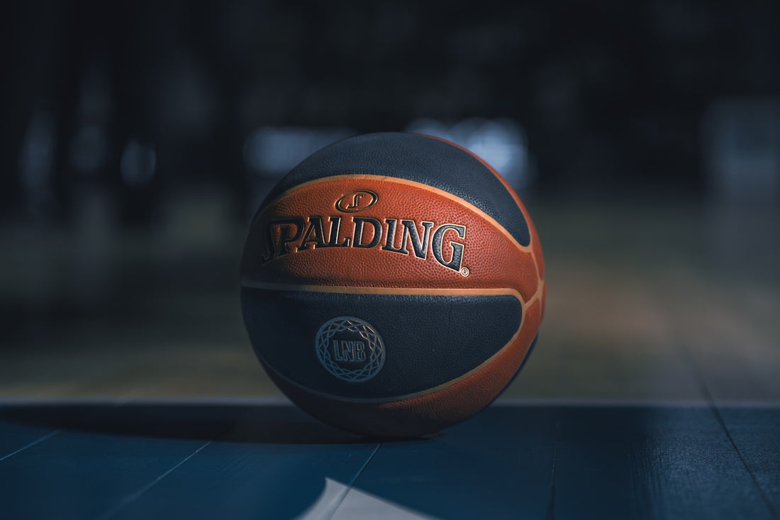 A spalding basketball rests on a court.